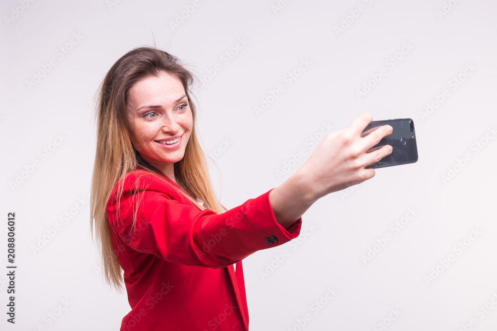 Young blond woman making selfie in studio Young blond woman making selfie in studio