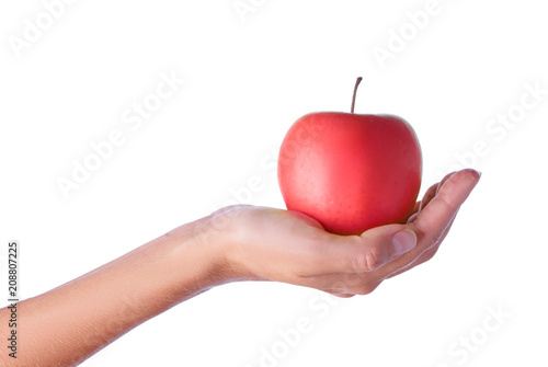 Close up studio shot of female hand holding fresh apple. Isolated on white background.