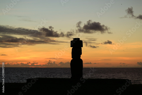 Beautiful sunset afterglow over Pacific ocean with the silhouette of Moai at Ahu Ko Te Riku, Tahai area, Easter Island, Chile  photo