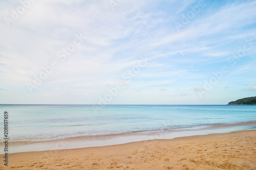 Sand beach with blue water and sky. © luengo_ua