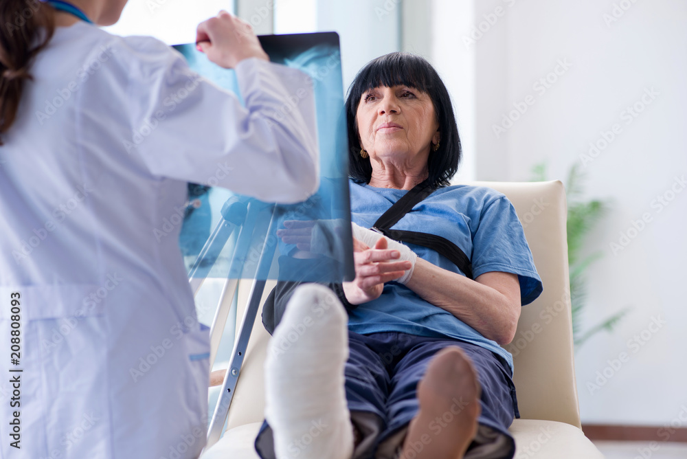 Doctor examining old mature woman after incident Doctor examining old mature woman after incident