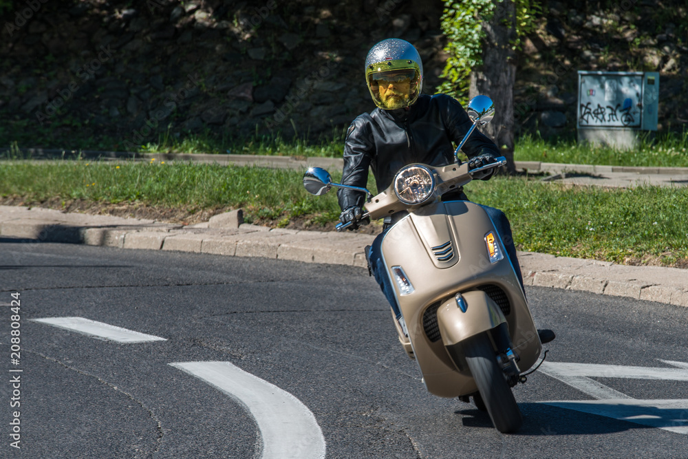 Fototapeta premium Man riding a classic scooter