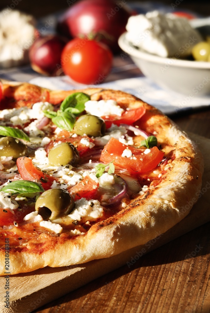 Homemade Greek Style Pizza / with tomatoes, red onions, feta cheese, olives, garlic and basil leaves Homemade Greek Style Pizza / with tomatoes, red onions, feta cheese, olives, garlic and basil leaves