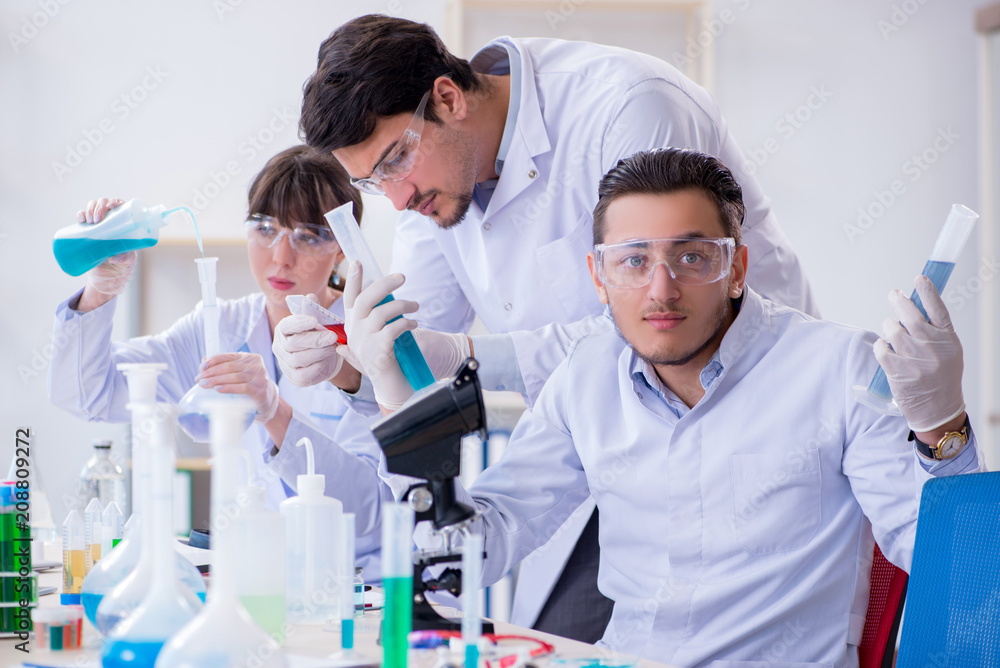 Team of chemists working in the lab Team of chemists working in the lab