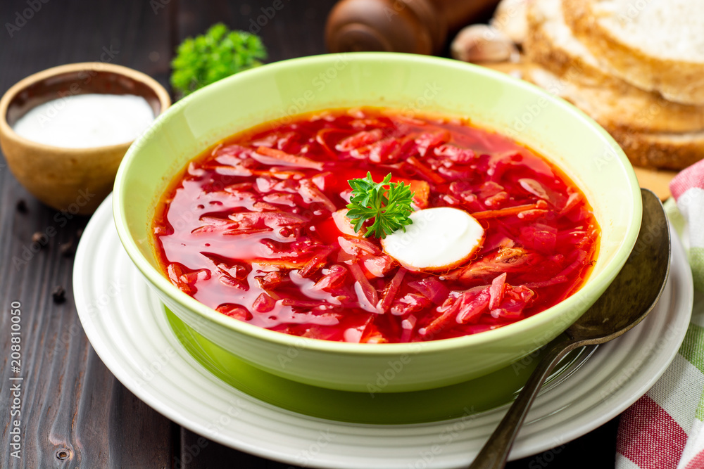 Borsch - traditional Ukrainian and Russian beetroot soup on dark wooden background Borsch - traditional Ukrainian and Russian beetroot soup on dark wooden background