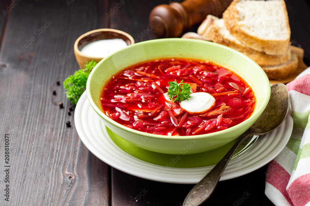 Borsch - traditional Ukrainian and Russian beetroot soup on dark wooden background Borsch - traditional Ukrainian and Russian beetroot soup on dark wooden background