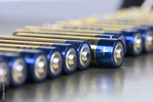 AAA alkaline batteries in perspective on metal background photo
