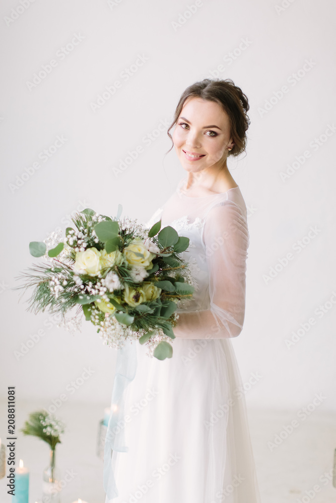 Beauty portrait of bride posing in the studio before the wedding ceremony in fashion wedding dress with luxury delight make-up and hairstyle, studio indoor photo. Beauty portrait of bride posing in the studio before the wedding ceremony in fashion wedding dress with luxury delight make-up and hairstyle, studio indoor photo.