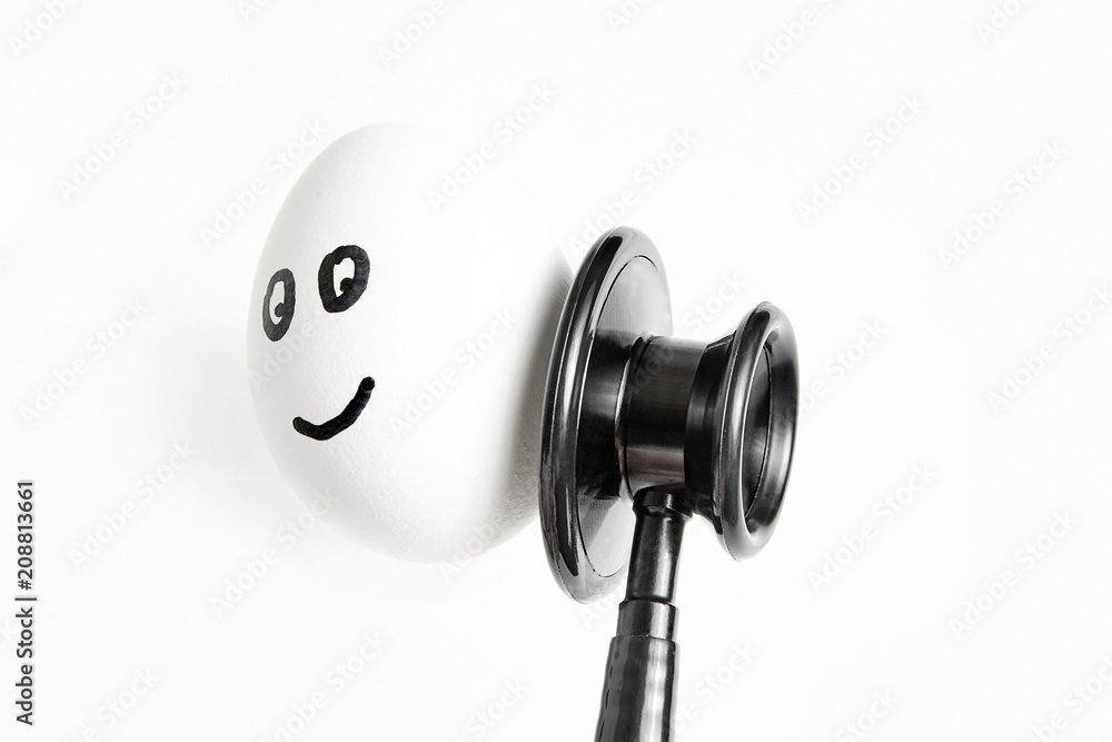 egg with painted eyes and smile. A stethoscope egg with painted eyes and smile. A stethoscope