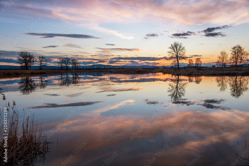 Sunset over calm lake , sky reflection in water. Sunset over calm lake , sky reflection in water.
