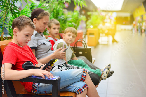 Mom with children on the bench in the mall. Photo with tinting photo