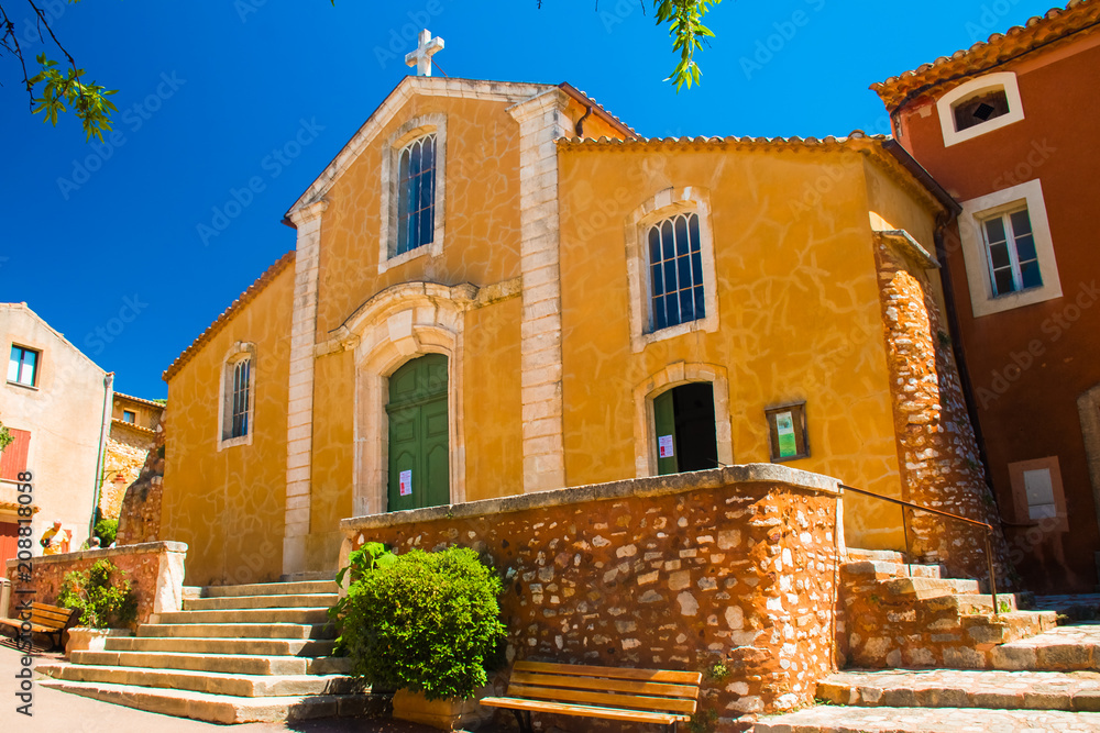 Colorful and ochre church in the Roussillon village, Provence, France