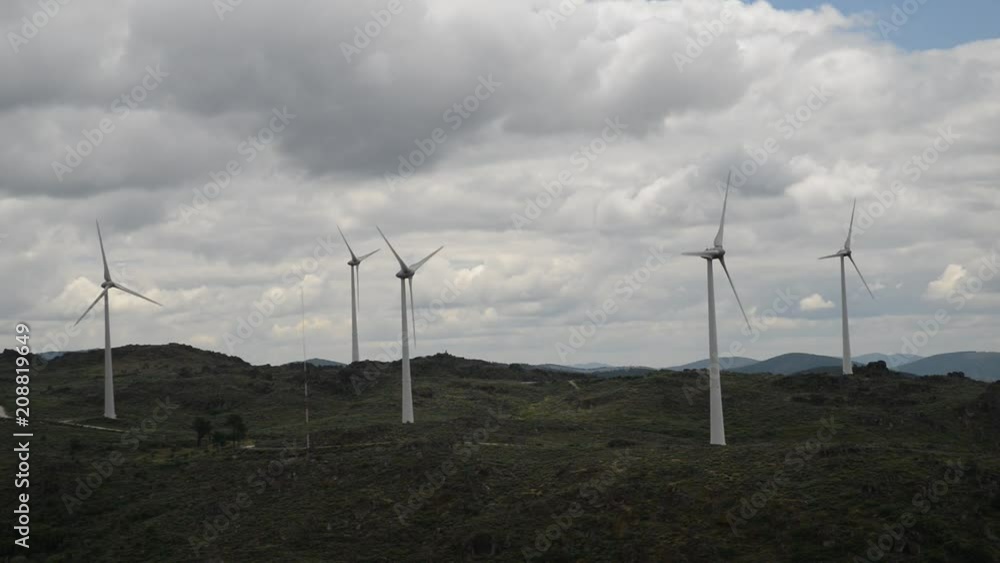 Real time of a wind turbine farm on top of a hill in Northeastern Portugal, renewable energy concept Real time of a wind turbine farm on top of a hill in Northeastern Portugal, renewable energy concept