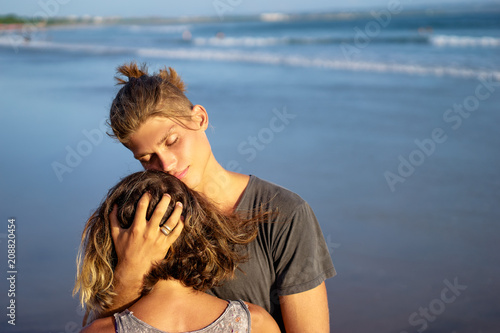 Love and romance. Honeymoon on the sea shore. Beautiful loving couple embracing on the beach. © luengo_ua