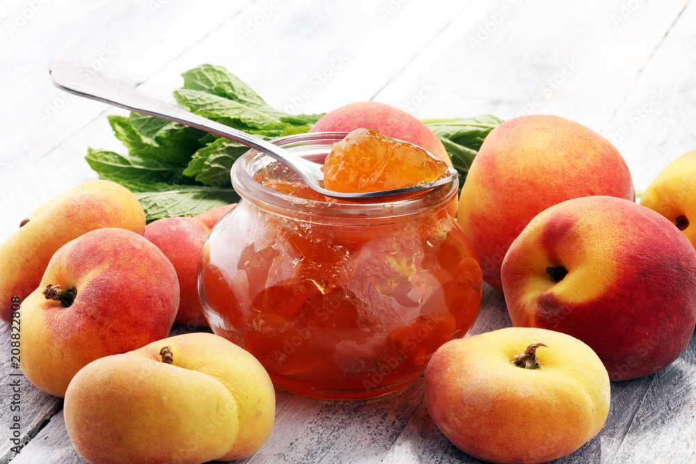 Peach vanilla jam with fresh peaches on table. Peach vanilla jam with fresh peaches on table.