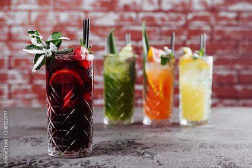 Obraz na plátně Four fruit cocktails on table.