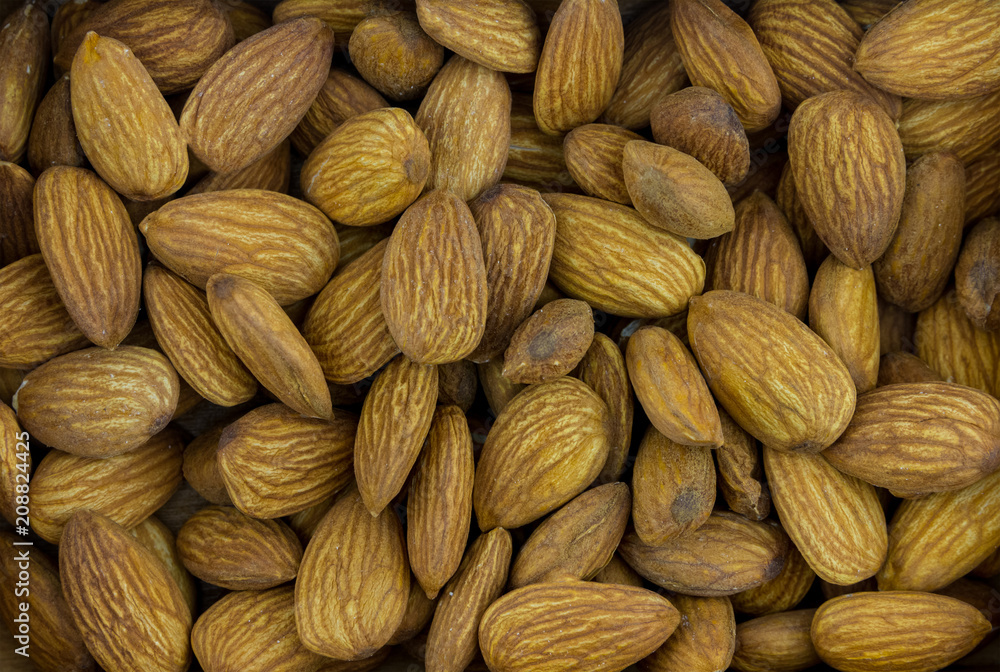 Fototapeta premium almonds large delicious walnut, base of desserts and marzipan, background base