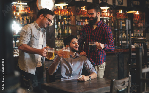 The guys in the pub are drinking beer