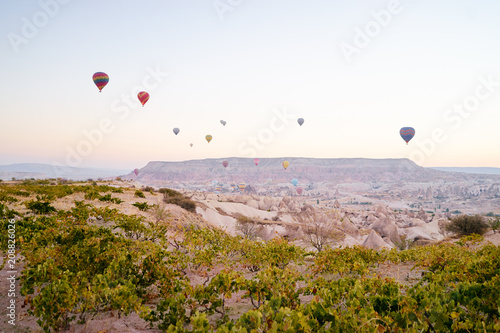Travel and tourism by Turkey. Famous sightseeing Cappadocia, Anatolia. Beautiful landscape with mountains, caves and baloons in the sky. © luengo_ua