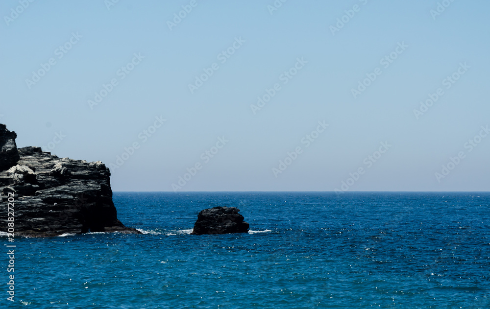 Amazing sea with blue summer wave and rocks, relaxing view of rocks and water Amazing sea with blue summer wave and rocks, relaxing view of rocks and water