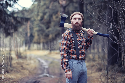 Tableau sur toile A bearded lumberjack with a large ax