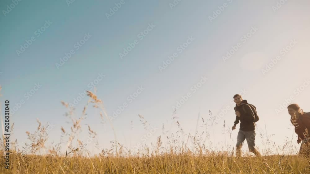 happy family are running slow motion video walking on nature boy run girl and mom in a field on trekking trip. tourists with a guitar backpacks traveling. happy lifestyle family run travel tourism happy family are running slow motion video walking on nature boy run girl and mom in a field on trekking trip. tourists with a guitar backpacks traveling. happy lifestyle family run travel tourism