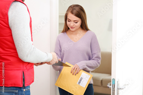 Woman signing for parcel de...