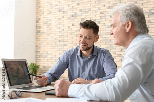 Male brokers working in off...