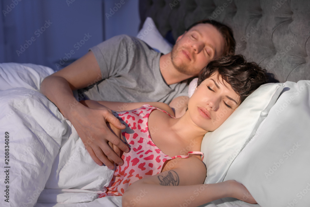 Young lovely couple sleeping in bed at home Young lovely couple sleeping in bed at home