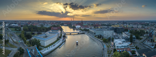 Widok z lotu ptaka na mosty, statek na rzece oraz zachodzące słońce - Wrocław, Polska