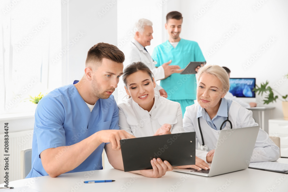 Group of doctors attending meeting in clinic. Cardiology conference