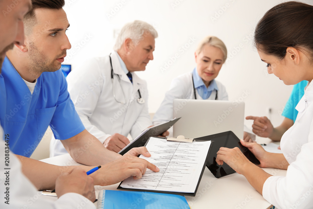Group of doctors attending meeting in clinic. Cardiology conference Group of doctors attending meeting in clinic. Cardiology conference