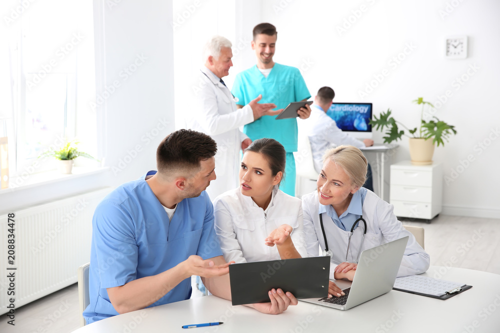 Group of doctors attending meeting in clinic. Cardiology conference Group of doctors attending meeting in clinic. Cardiology conference