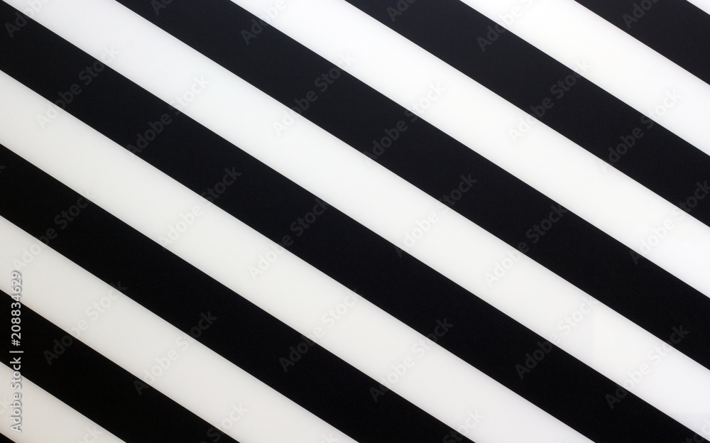 Fragment of a striped black and white piece of a plastic as a background texture Fragment of a striped black and white piece of a plastic as a background texture