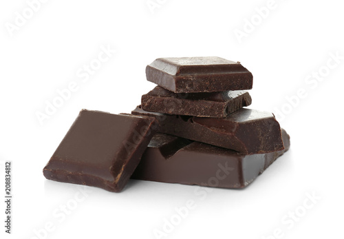 Delicious black chocolate pieces on white background
