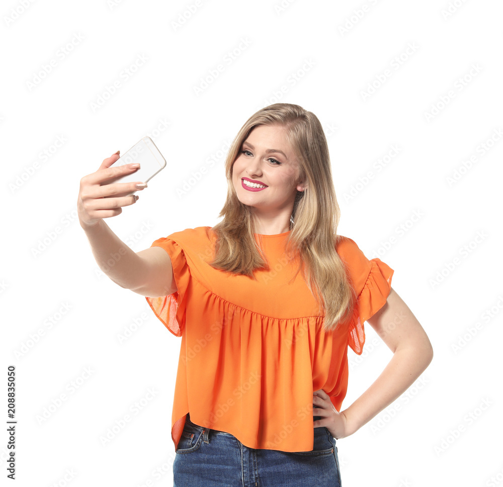 Attractive young woman taking selfie on white background Attractive young woman taking selfie on white background