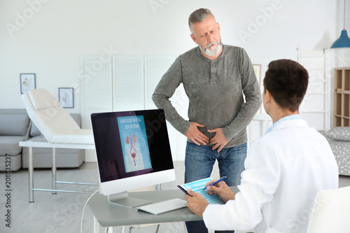 Man with health problem visiting urologist at hospital photo