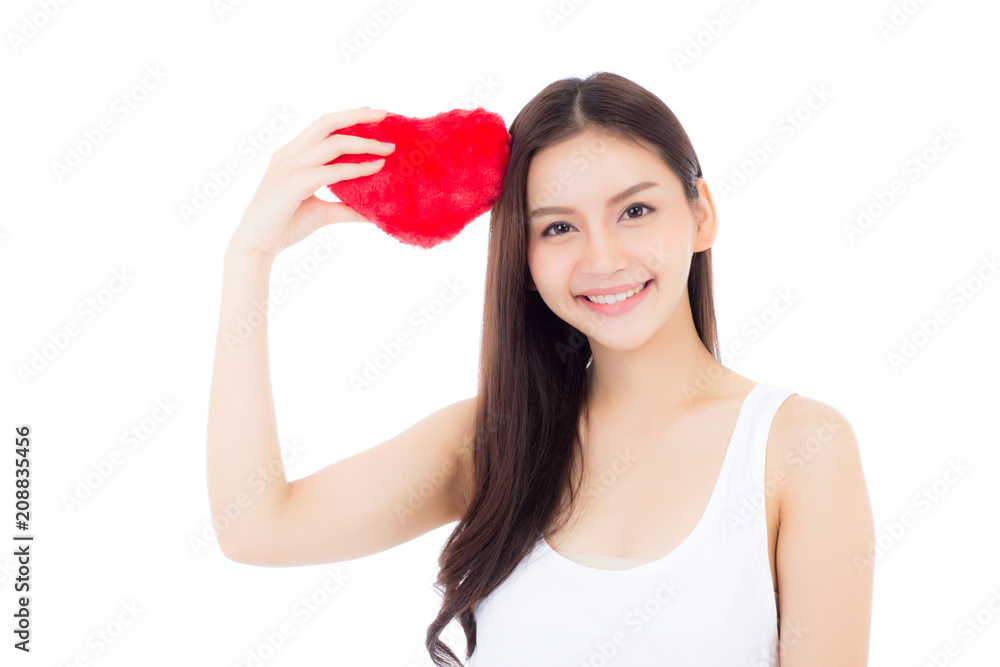 Portrait of beautiful asian young woman holding red heart shape pillow and smile isolated on white background, valentines day, holiday concept. Portrait of beautiful asian young woman holding red heart shape pillow and smile isolated on white background, valentines day, holiday concept.