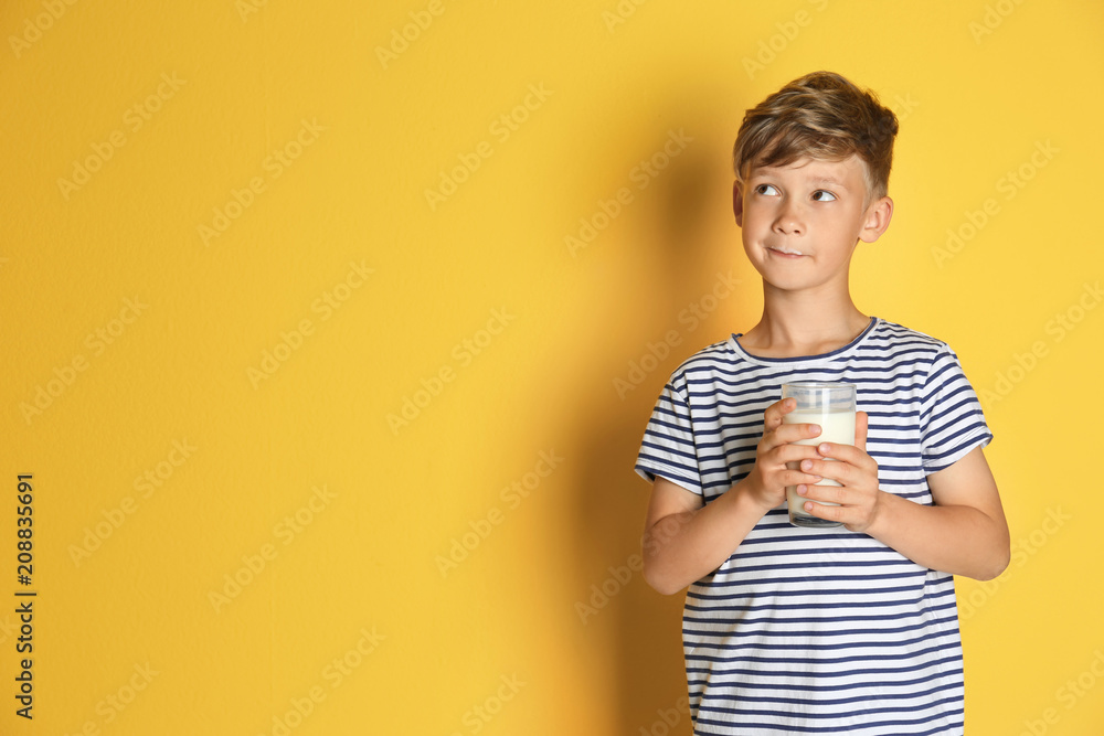 Adorable little boy with glass of milk on color background Adorable little boy with glass of milk on color background