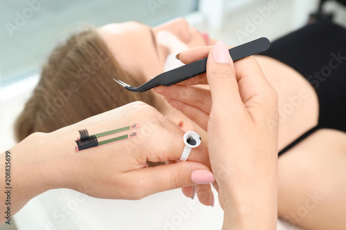 Beautician preparing for eyelash extensions procedure  closeup