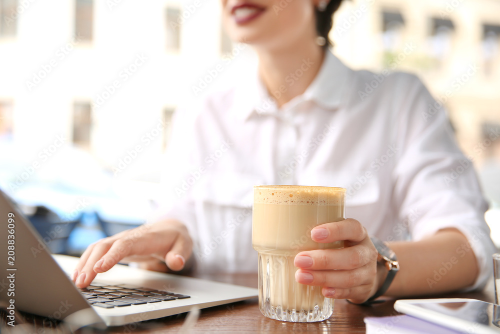 Young woman working with laptop at desk, closeup Young woman working with laptop at desk, closeup