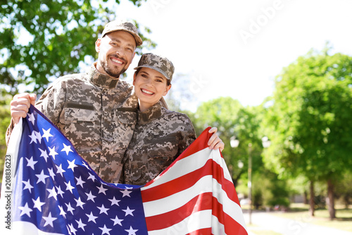 Photography Military couple with American flag in park