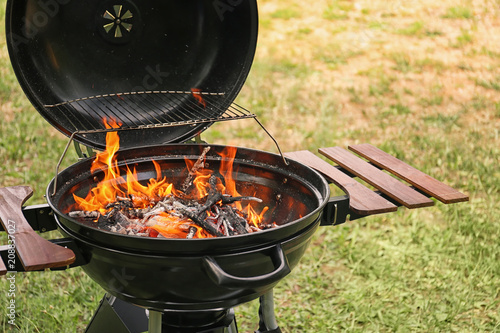 Modern barbecue grill with fire flames outdoors