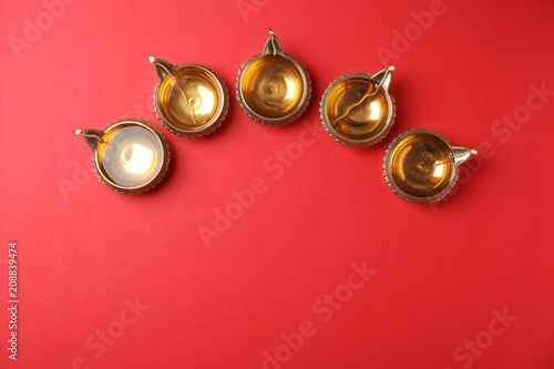 Diwali diyas or clay lamps on color background, top view
