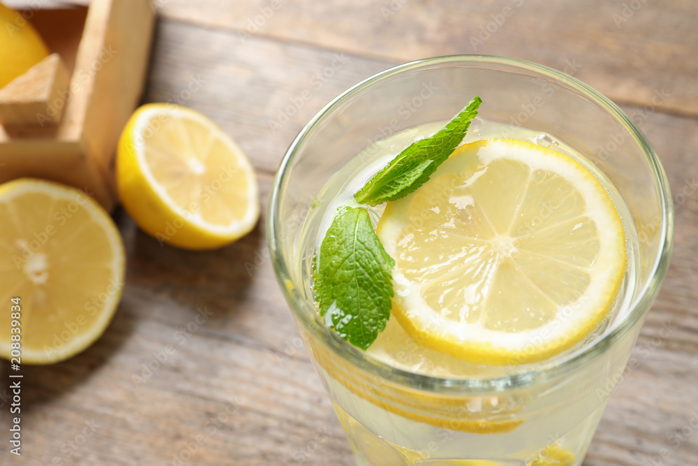 Glass of natural lemonade with mint on table, closeup Glass of natural lemonade with mint on table, closeup