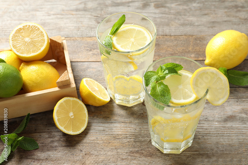 Glasses of natural lemonade with mint on table