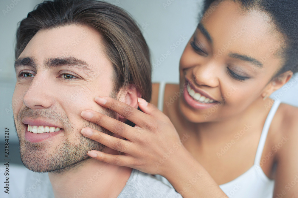 selective focus of happy multiethnic couple in love at home selective focus of happy multiethnic couple in love at home