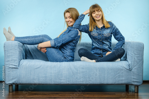 Two happy women friends wearing jeans outfit