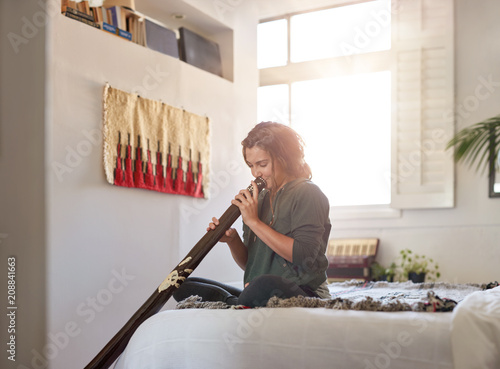 Alternative unusual musical instrument didgeridoo player at home photo