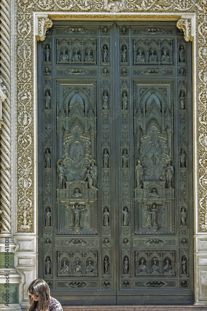 The ornate bronze door of the Basilica di Santa Maria del Fiore,  Florence, Italy